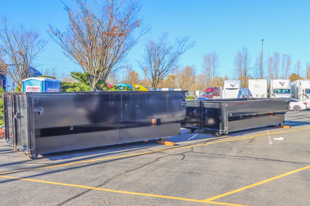 Professional dumpster rental service with roll-off container on residential driveway in Leisure World